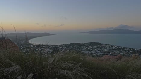 A-View-From-Castle-Hill-Lookout-In-Townsville-Australia,-Stunning-Sunset-Sky-And-Sea---handheld-shot