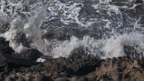 4k-close-up-of-Ocean-Waves-Hitting-the-Beach-Sand-Stone-Beach