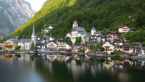 Homes-Reflect-off-Hallstatt-Lake-in-Austria's-Famous-Alpine-Village