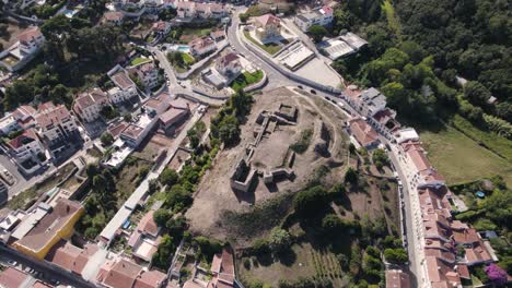 Ruins-of-medieval-castle-in-the-civil-parish-of-Alcobaça,-aerial-orbiting-shot-above-view