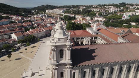 Details-front-facade-of-Alcobaca-Monastery,-gothic-and-baroque-complex-of-building,-aerial-pan-shot