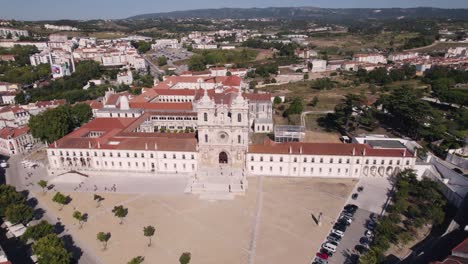 Aerial-pull-out-shot-reveals-spectacular-Alcobaça-Monastery-catholic-monastic-complex-and-cityscape