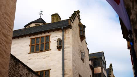 Looking-up-at-old-stone-Conwy-historical-town-picturesque-medieval-townhouse-attraction-dolly-left