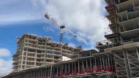Construction-crane-building-residential-condominium-development-in-downtown-city