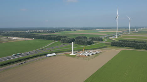 Aerial-of-windmill-under-construction-near-highway