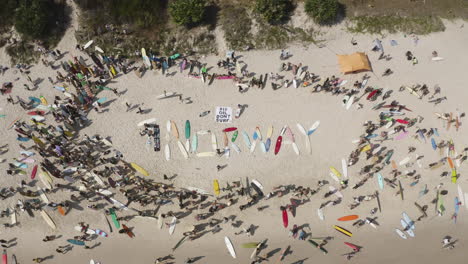 4k-Top-view-drone-shot-of-the-protest-on-the-beach-shore-against-norwegian-oil-company-at-Byron-Bay,-New-South-Wales,-Australia---2019