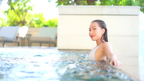 Sexy-Asian-Woman-in-Jacuzzi-Pool-in-Spa-Center-of-Luxury-Hotel,-Full-Frame-Slow-Motion