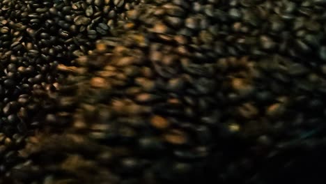 Freshly-Roasted-Dark-Coffee-Beans-Being-Mixed-and-Rotated-by-a-Professional-Machine-with-Close-Up-Detail