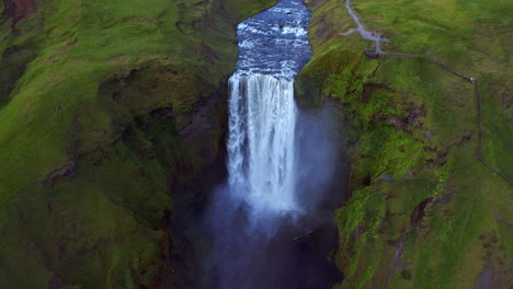 Aerial-Of-Skogafoss-Waterfall-Flowing-From-Towering-Cliff-Situated-On-Skoga-River-In-South-Of-Iceland