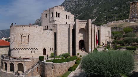 Entrance-of-historic-museum-of-Skanderbeg-in-Kruja-castle,-stone-walls-on-new-architecture