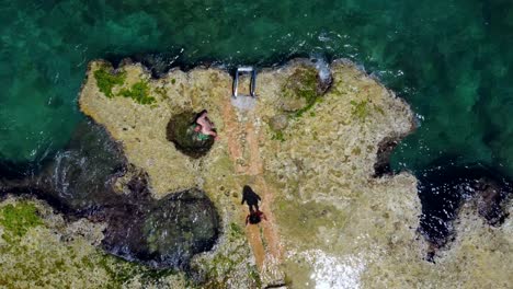 Couple-enjoying-a-natural-pool-by-the-sea-in-Lebanon--Top-view