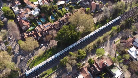 Aerial-top-down-view-of-a-Train-in-Vicente-López-residential-area-Buenos-Aires,-Argentina