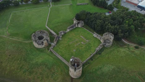 Flint-castle-Welsh-medieval-coastal-military-fortress-ruin-aerial-view-high-right-rotate