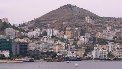High-rise-concrete-buildings-built-on-hill-in-Southern-Europe-in-front-of-harbor
