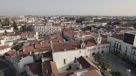 Aerial-pan-shot-capturing-church-of-aveiro's-mercy,-district-council-populated-cityscape-from-above