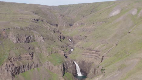 Spectacular-volcanic-mountainous-river-flowing-with-waterfall-in-Iceland,-Bessastaðargil