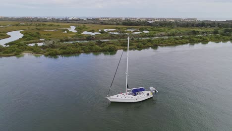 Orbital-shot-of-sailboat-with-lifeboat-in-Florida-wetlands