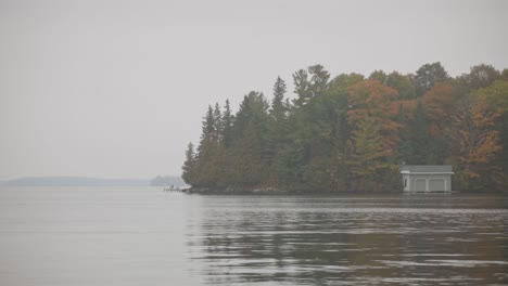 Misty-Lake-With-Tranquil-Water-In-Dull-Autumn-Day---wide-shot