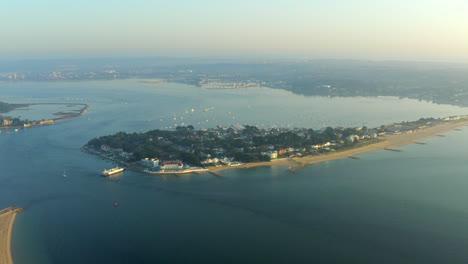 A-sweeping-aerial-shot-of-Sandbanks-and-Poole-Harbour-on-English-coast-at-Golden-hour-in-the-British-summer