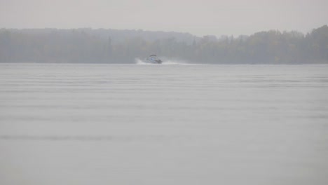 Misty-Lake-During-Autumn-Season-With-Sailing-Motor-Boat