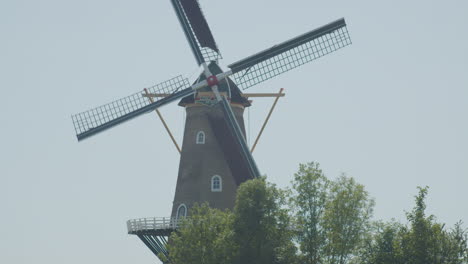 Tilt-up-from-hikers-to-a-beautiful-classic-windmill-in-the-Netherlands