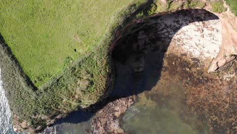 Aerial-View-Of-Scenic-English-Coastal-Cliff-And-Cove-In-Devon