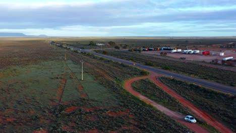 Aerial-View-of-Stuart-Highway-with-parking-area-for-trucks-near-Port-Augusta---Victoria,-Australia