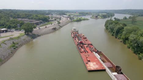Aerial-flyover-of-a-barge-on-the-Cumberland-River-in-Clarksville-Tennessee