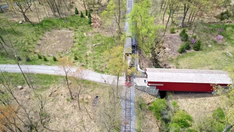 An-Aerial-View-of-an-1860's-Steam-Passenger-Train-Traveling-Thru-a-Wooded-Area-on-a-Lonely-Single-Track