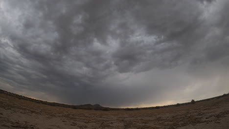 Sunrise-is-greeted-by-a-brief-cloudburst-over-the-drought-stricken-landscape-of-the-Mojave-Desert---time-lapse