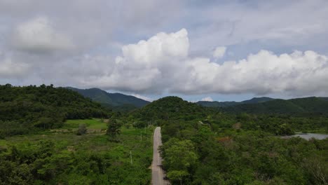 An-aerial-footage-of-a-paved-road-going-in-Kaeng-Krachan-National-Park,-UNESCO-World-Heritage-site,-Thailand