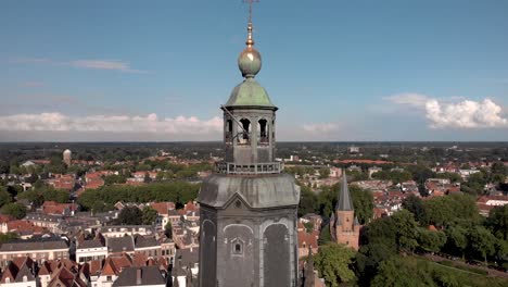 Slow-aerial-descend-showing-tower-and-ship-of-Walburgiskerk-cathedral-in-medieval-Hanseatic-town-of-Zutphen-in-The-Netherlands