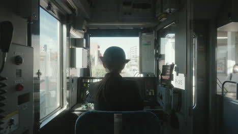 Back-View-Of-A-Female-Conductor-Preparing-The-Train-Cab-Before-Departure-At-The-Railway-Station-In-Sendal,-Japan