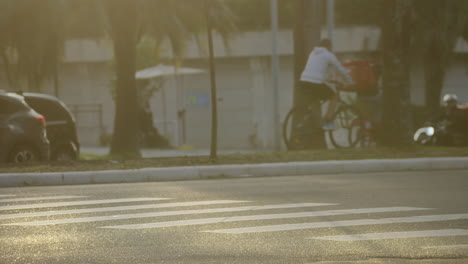 Bicycles-riding-in-the-bike-lane-of-a-big-city-under-the-sunset-golden-light-filmed-in-slow-motion-in-4K-high-definition