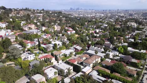 Rising-aerial,-over-rich-Hollywood-homes,-downtown-Los-Angeles