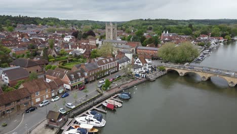 Henley-on-Thames-,-Henley-bridge-boats-moored-on-waterfront-Oxfordshire-UK-Aerial-footage