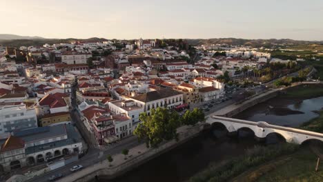 Aerial-cityscape-of-the-beautiful-historic-town-of-Silves-in-Portugal,-showing-the-city-streets-and-countryside-surrounding,-bright-summers-day