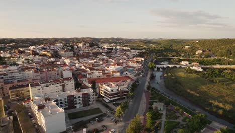 Aerial-orbit-shot-over-Silves-town-and-Arade-River-in-the-Algarve,-Portugal