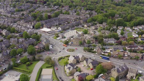 Aerial-drone-shot-of-cars-at-busy-roundabout-junction-in-rural-British-countryside