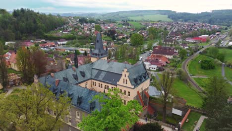 aerial-view-of-the-castle-in-Zruc-nad-Sazavou,-Czechia-with-the-city-in-background