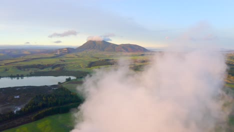 Magical-serene-farm-land-countryside-of-New-Zealand-with-cloud,-aerial