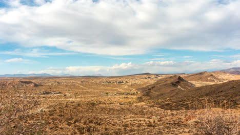 From-a-scenic-overlook,-view-the-clouds-cross-the-sky-over-Red-Rock-Canyon-State-Park---time-lapse