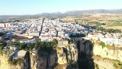 AERIAL---Cityscape-of-the-town-of-Ronda,-Malaga,-Spain,-landscape-shot-pan-left