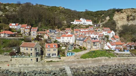 Aerial-sideways-view-of-cottages-at-Runswick-Bay,-Yorkshire-Coast