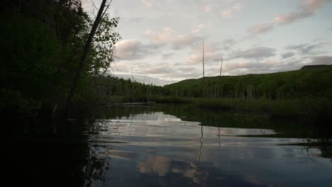 Reflection-On-Still-Water-Of-A-Lake-At-The-Forest-During-Sunset-At-Le-Vertendre-In-Eastman,-Quebec-Canada