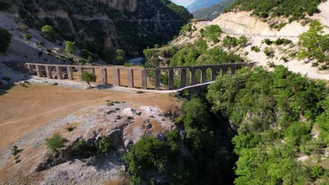 Ancient-aqueduct-with-stone-arched-walls-built-on-valley-of-Vjosa-river-in-Albania