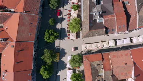 Aerial-flyover-of-an-alley-of-shops-and-cafes-in-Novi-Sad,-Serbia