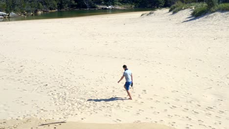 Male-Tourist-Walking-Alone-During-Hot-Summer-On-Sandy-Beach-In-Royal-National-Park,-New-South-Wales,-Australia