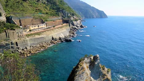 First-person-view-of-legs-dangling-in-the-air-at-Cinque-Terre,-Italy