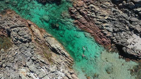 People-Swimming-and-Snorkeling,-Birdseye-Drone-Aerial-View,-Lagoon-Between-Rocks-on-Australian-Coastline,-The-Aquarium,-Cape-Naturaliste